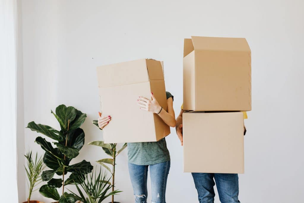 Deux personnes tenant des cartons de déménagement